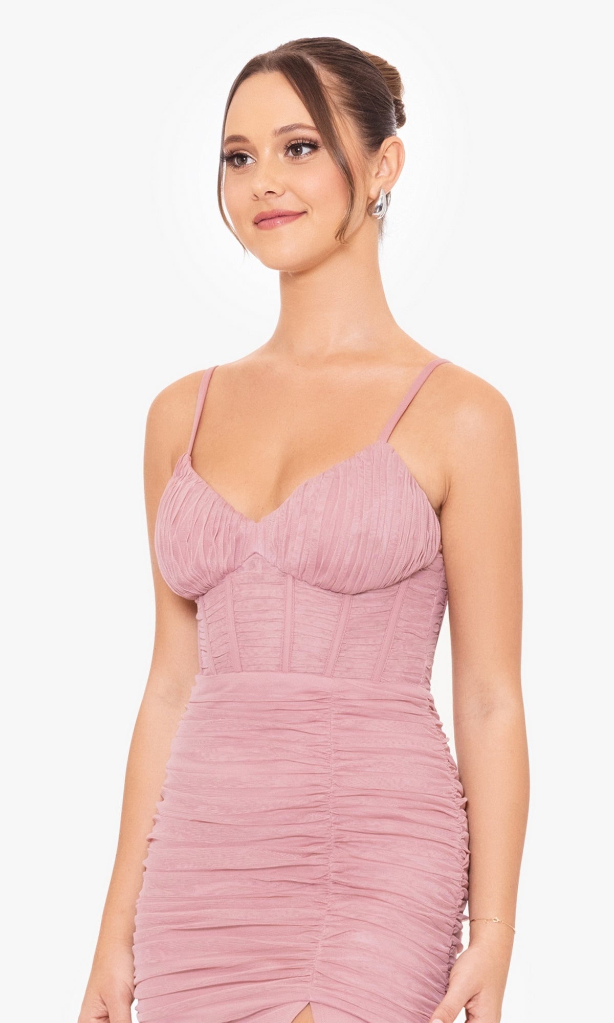 Woman wearing the Corset-Bodice Long Mermaid Prom Dress 4682BN, featuring a mauve ruched spaghetti strap design, with her hair in an updo, standing against a plain white background.